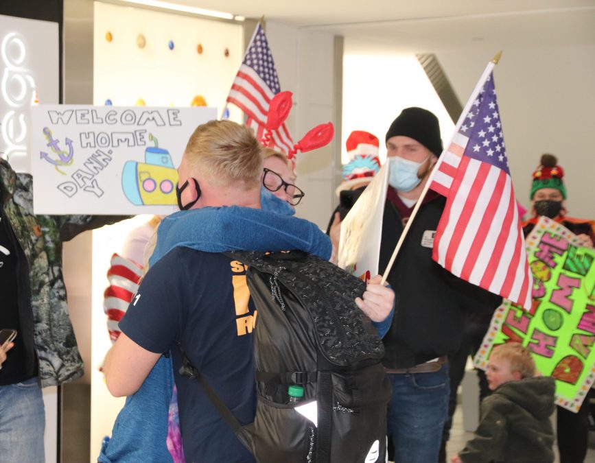 Photo of people embracing with American flags.