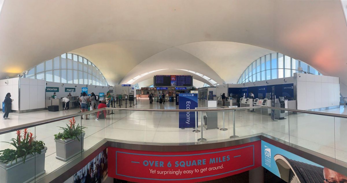 Photo of the interior lobby of an airport with a colorful banner at the bottom