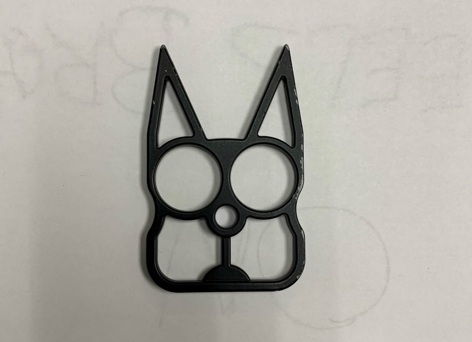 Photo of a piece of metal with sharp edges and shaped like a cat