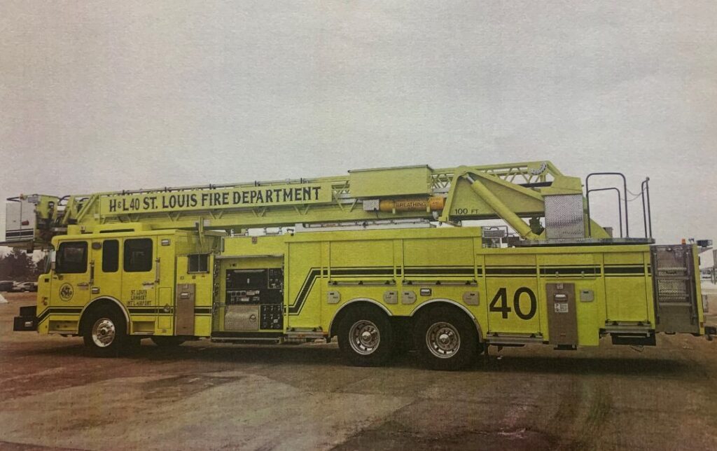 Photo of a yellow hook and ladder firefighting vehicle