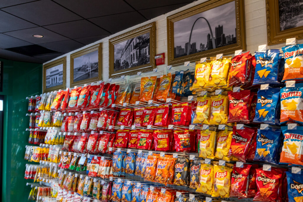 This photo shows the wide variety of snacks available at Lafayette Square Mkt. The back wall of the shops has six rows of a wide variety of products.