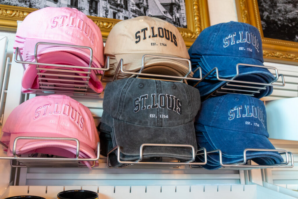 This photo shows a display of St. Louis branded hats in a variety of colors.