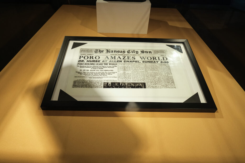 This image shows a framed newspaper article from The Kansas City Sun with the headline "Poro Amazes World."