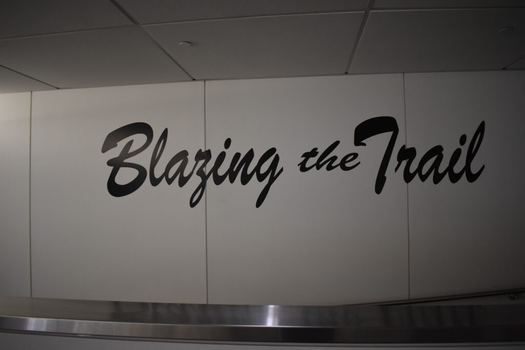 This image features the phrase "Blazing the Trail" prominently displayed in large, stylized black script on a white wall.