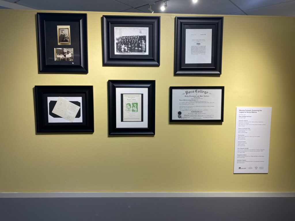 This image shows a display of framed archival materials from Poro College, including photographs, documents, and certificates.