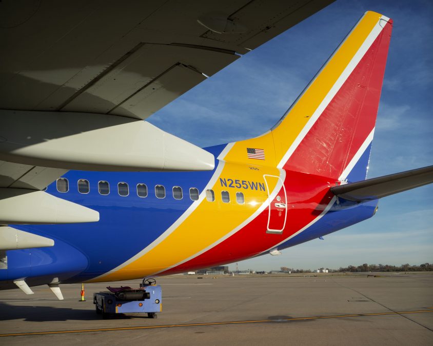 Photo of the back of a multicolored plane