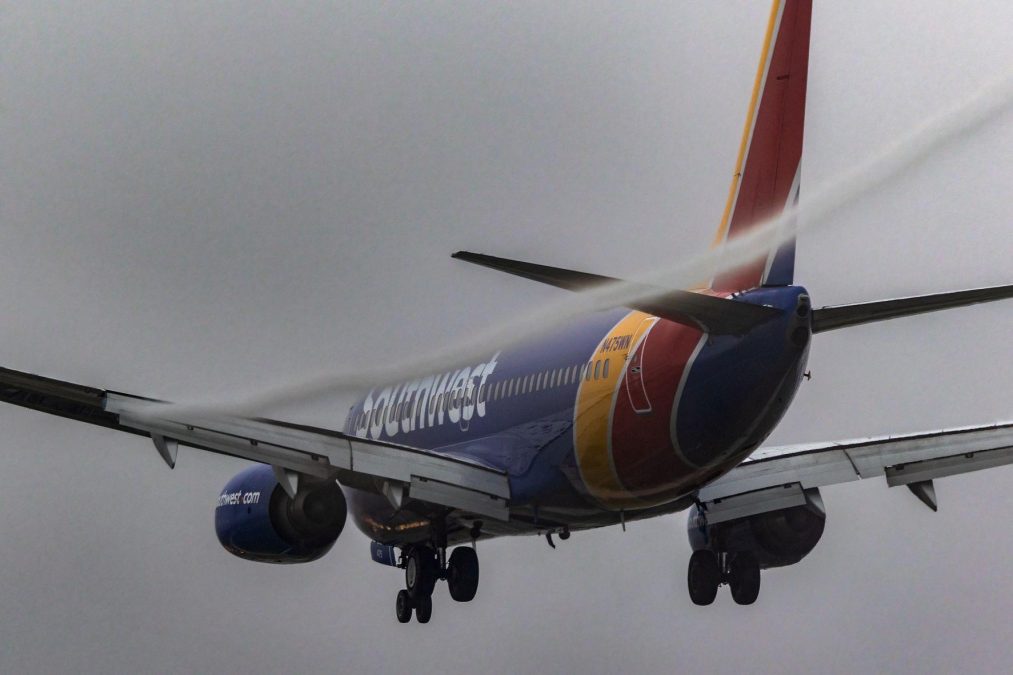 Photo of a Southwest Airlines plane with a stream of vapor emitting from one wing