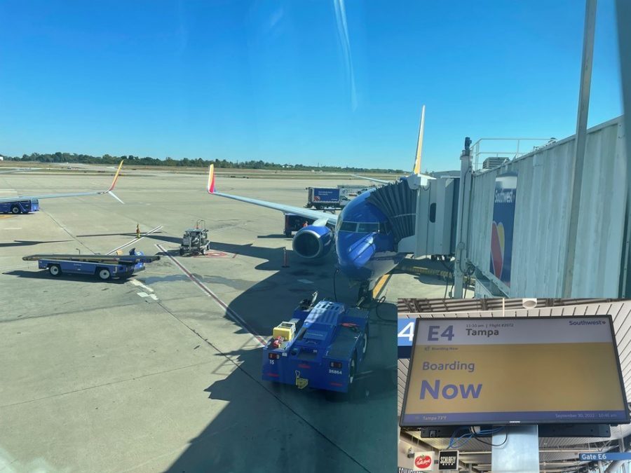 Photo of a Southwest Airlines plane parked at an airport gate with the jet bridge extended towards the plane