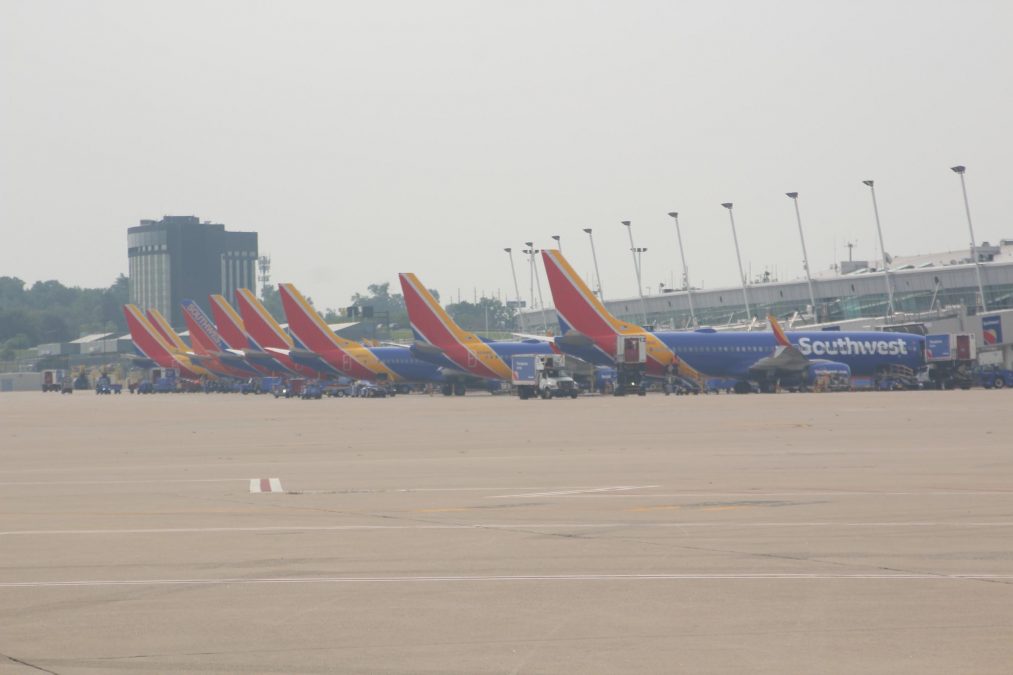 A photo of the back of multiple Southwest Airlines planes lined up on an airport tarmac