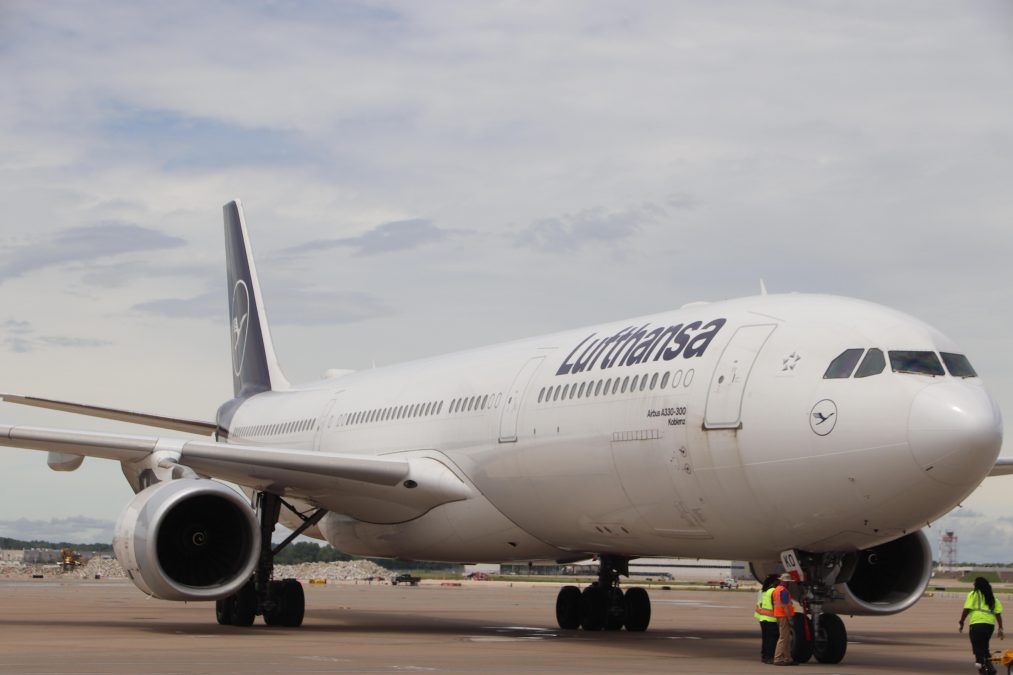 Photo of the front/side profile of a Lufthansa plane on a runway