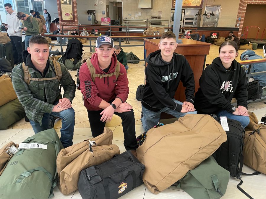 Photo of four marines at the airport terminal.