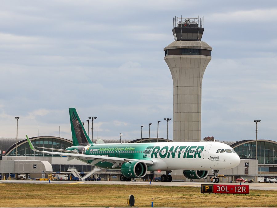 A Frontier airlines plane pulls away from the gate.