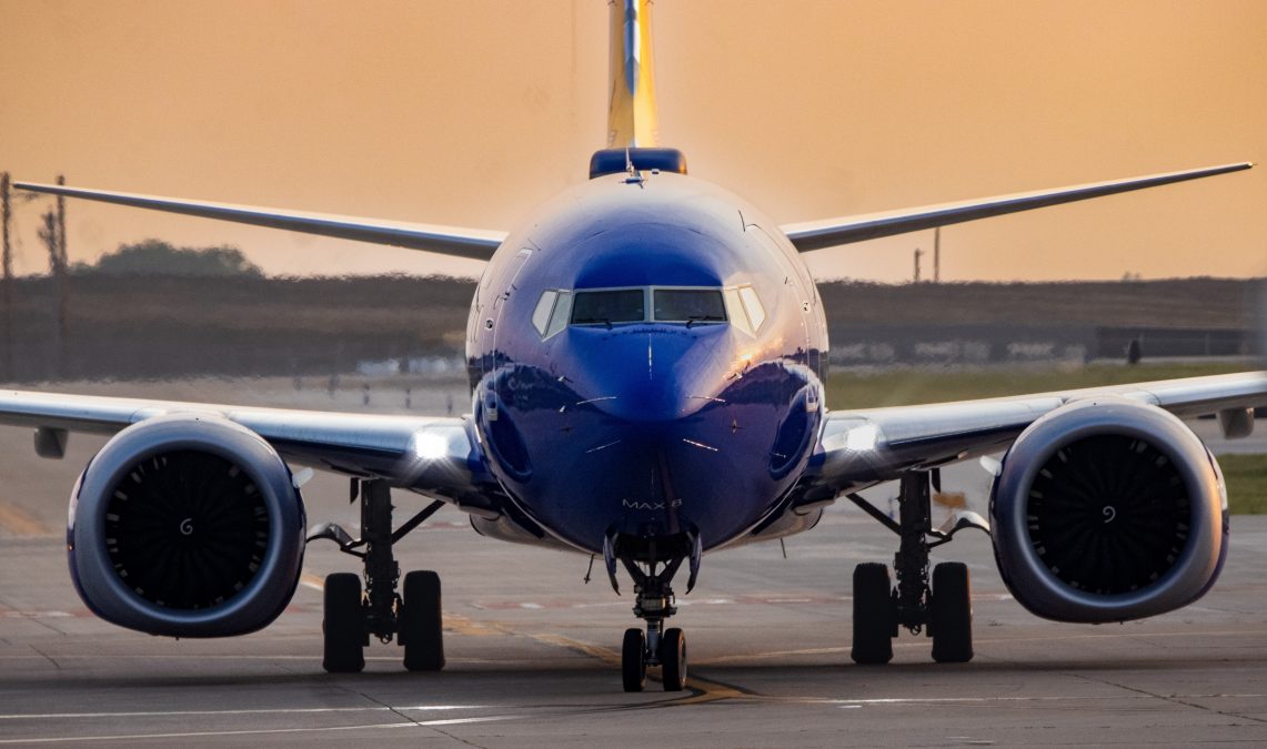 Blue and yellow Southwest airplane rolling down the taxiway.