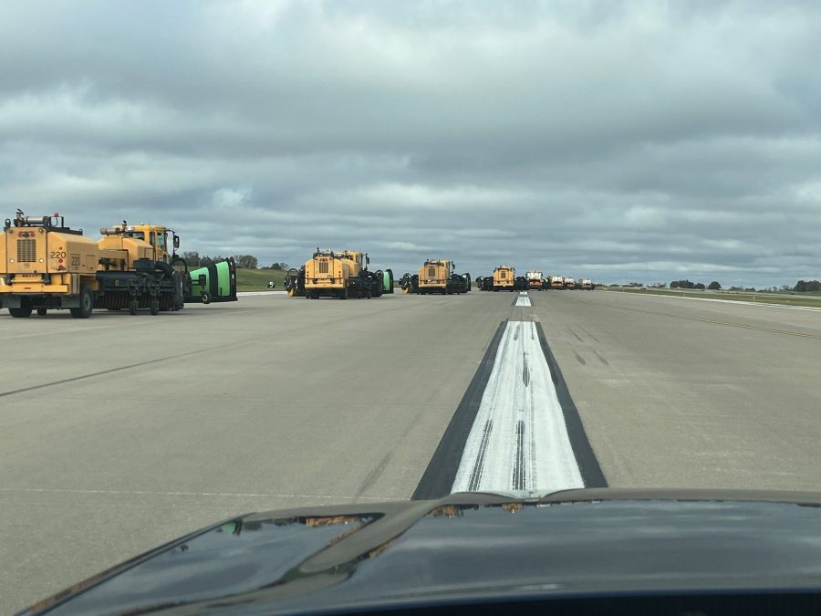 Photo of snow plows assembling on the STL airport runway.