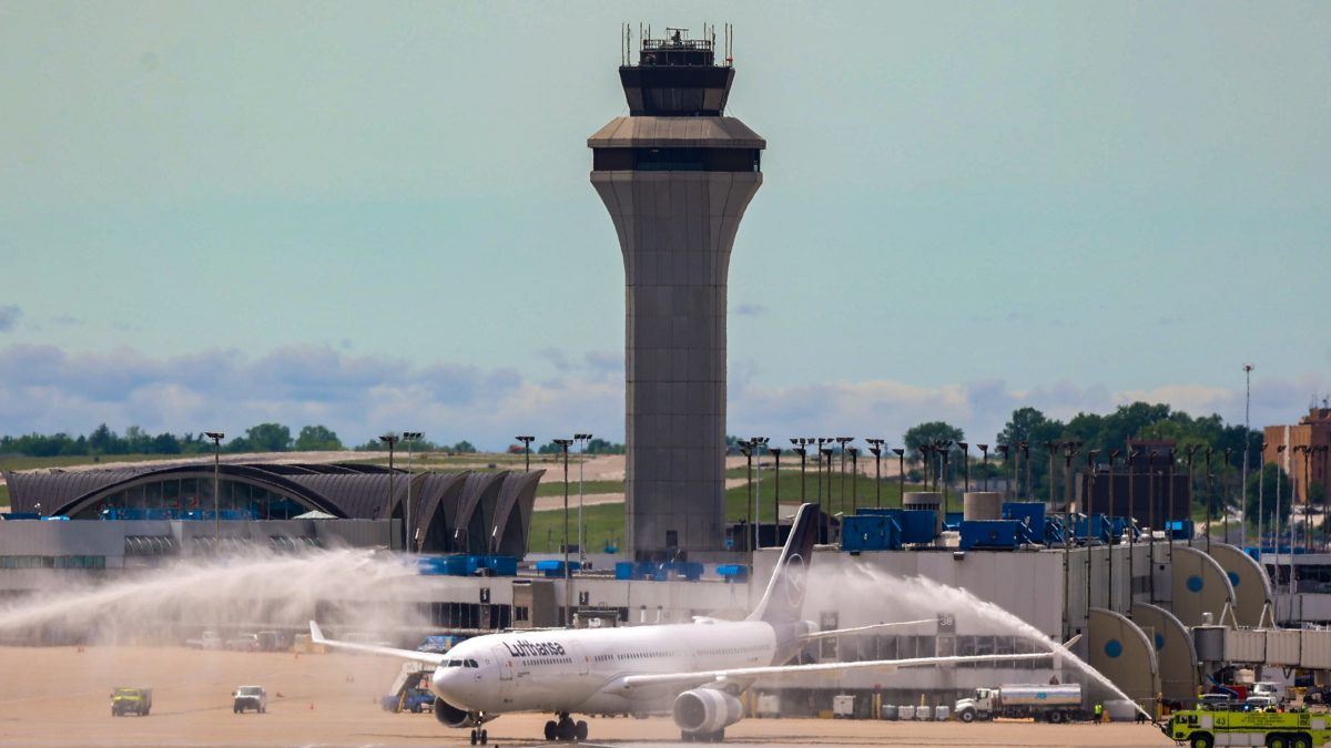 Photo of a Lufthansa plane getting sprayed with water by STL firetrucks.