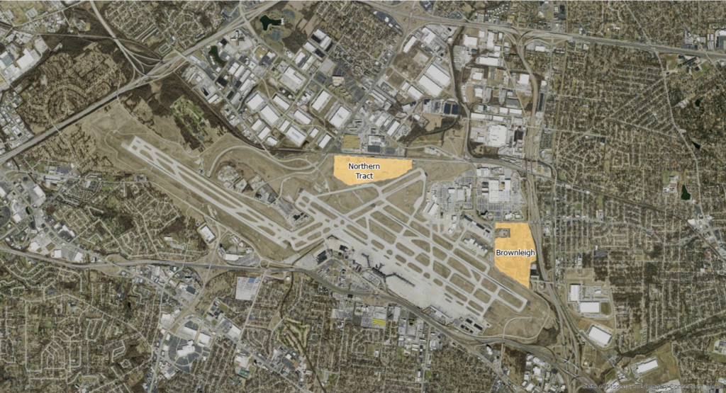 An aerial view of an airport and its surrounding area, with two highlighted land parcels labeled 'Northern Tract' and 'Brownleigh.' The airport features multiple runways, taxiways, and terminal areas, with adjacent industrial and residential zones. The 'Northern Tract' is situated just north of the airport, near a cluster of warehouses and commercial buildings, while 'Brownleigh' is located southeast of the airport, closer to a residential neighborhood. The map provides a geographical overview of these land areas in relation to the airport infrastructure.
