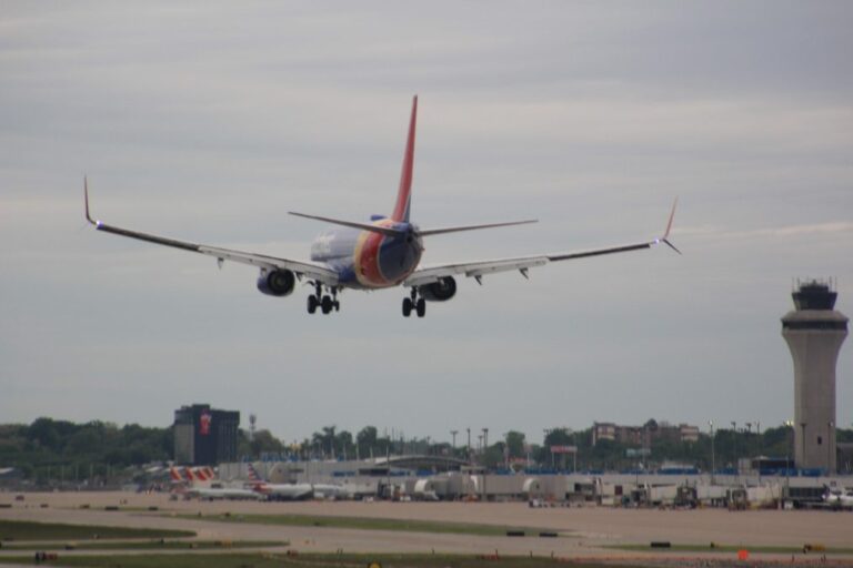 A southwest airlines plane approaches the runway for landing.