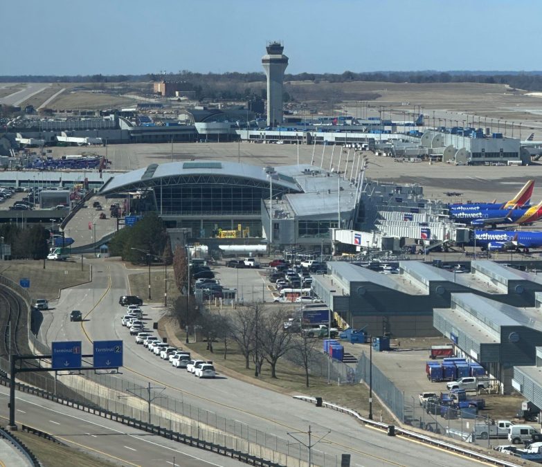 Aerial photograph of St. Louis Lambert International Airport on a clear day, offering a sweeping view of the terminal complex, runways, and surrounding infrastructure