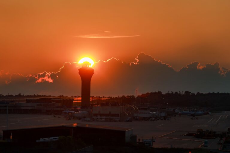 The sunset is setting just above the tower making it look like a light beacon.