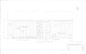 Architectural floor plan drawing of a rectangular building, showing labeled rooms, walls, doorways, and measurements. The title block in the lower right corner includes project details and signatures. Lines and notes fill the central space.