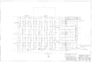 Black and white architectural floor plan showing the layout of columns, beams, and structural elements for a building’s first floor, with labels, dimensions, and construction notes around the drawing.