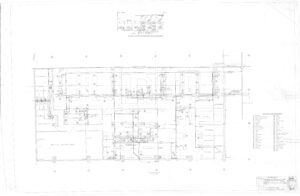 Faint, detailed architectural floor plan with rooms labeled, symbols for plumbing and electrical features, a legend on the right, and a small detail drawing at the top.