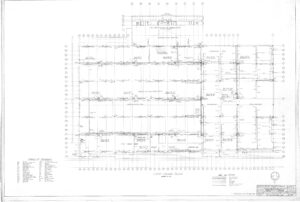 Architectural floor plan drawing showing the layout of Ernest L. Thomas School with labeled rooms, walls, doors, and structural elements. Includes a table of symbols, scale, and project details in the bottom corners.