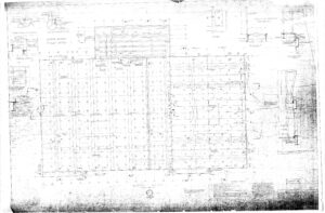 Faded architectural blueprint showing a detailed floor plan with labeled measurements, sections, and construction notes. Various structural elements and technical details appear across the drawing.