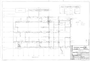 Architectural floor plan blueprint of an office building with labeled rooms, walls, doors, measurements, electrical symbols, and a title block in the bottom right corner displaying project details and company logo.