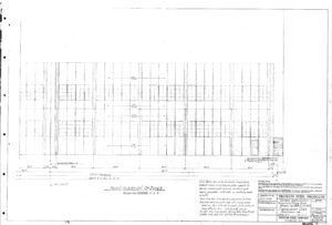 Faint architectural drawing of a building’s facade, featuring vertical and horizontal grid lines, labeled measurements, windows, and a door. Title block in the lower right corner shows project and company details.