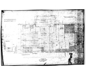 A faded architectural blueprint with grid lines, various shaded and hatched sections, notes, and dimensions, depicting a detailed floor plan for a building or construction project.