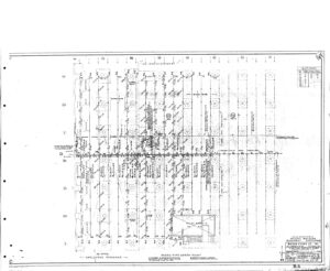 A detailed engineering floor plan with structural grid lines, annotations, symbols, and measurements for a safety plant building. The drawing includes a title block and revision notes in the lower right corner.