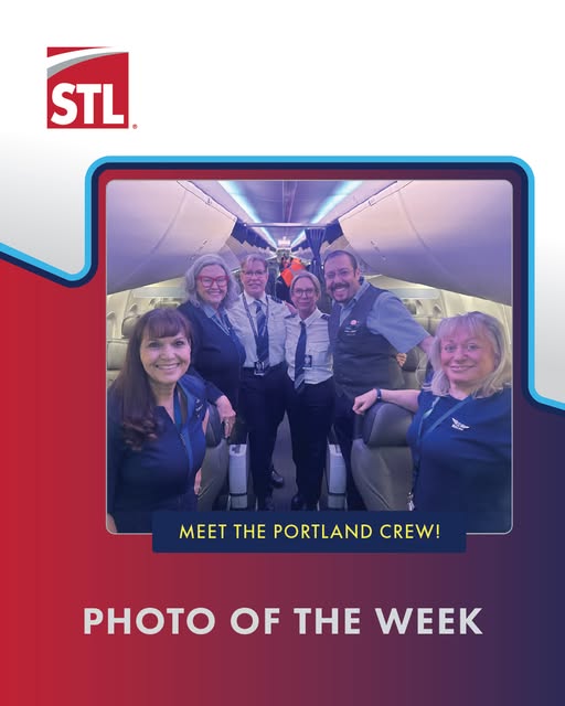 Five airline crew members stand smiling inside an airplane cabin. A banner reads Meet the Portland Crew! and Photo of the Week. The STL logo is at the top left of the image.