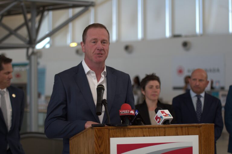 This photo shows Sen. Eric Schmitt behind a podium at St. Louis Lambert International Airport on May 28, 2026 addressing media regarding an FAA grant.
