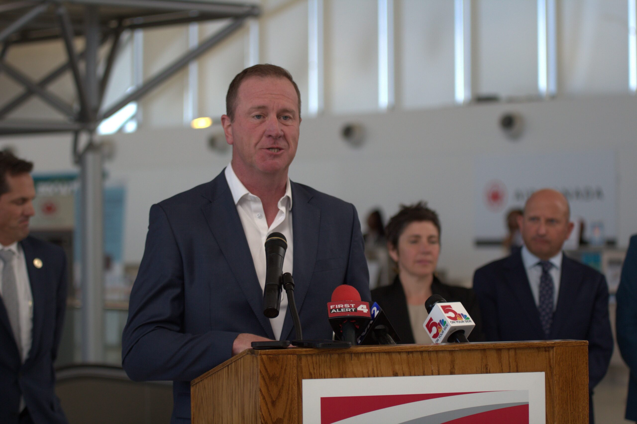 This photo shows Sen. Eric Schmitt behind a podium at St. Louis Lambert International Airport on May 28, 2026 addressing media regarding an FAA grant.