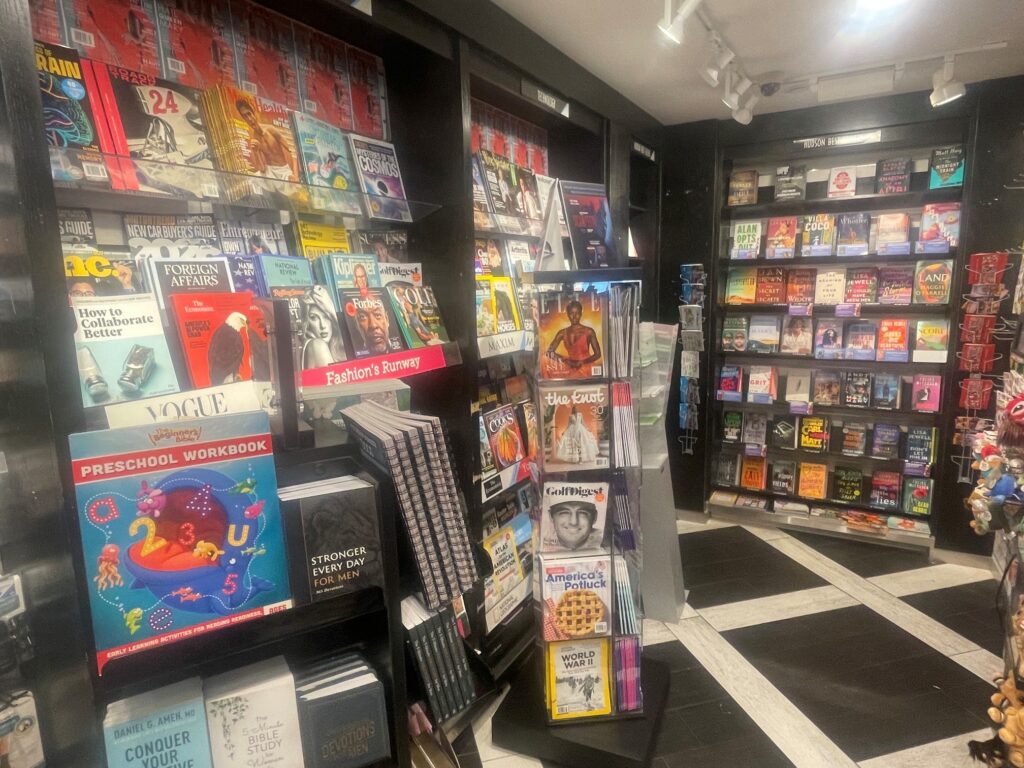 The back area of the Riverbend market in STL's Concourse C has four display cases of publications and greeting cards,